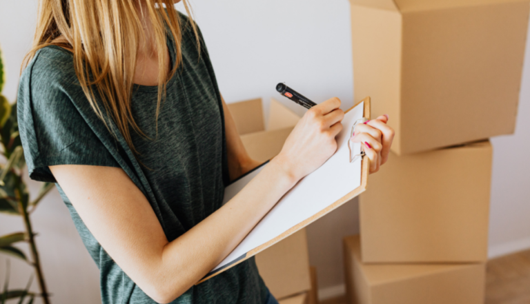 a girl writing and checklist all the moving items